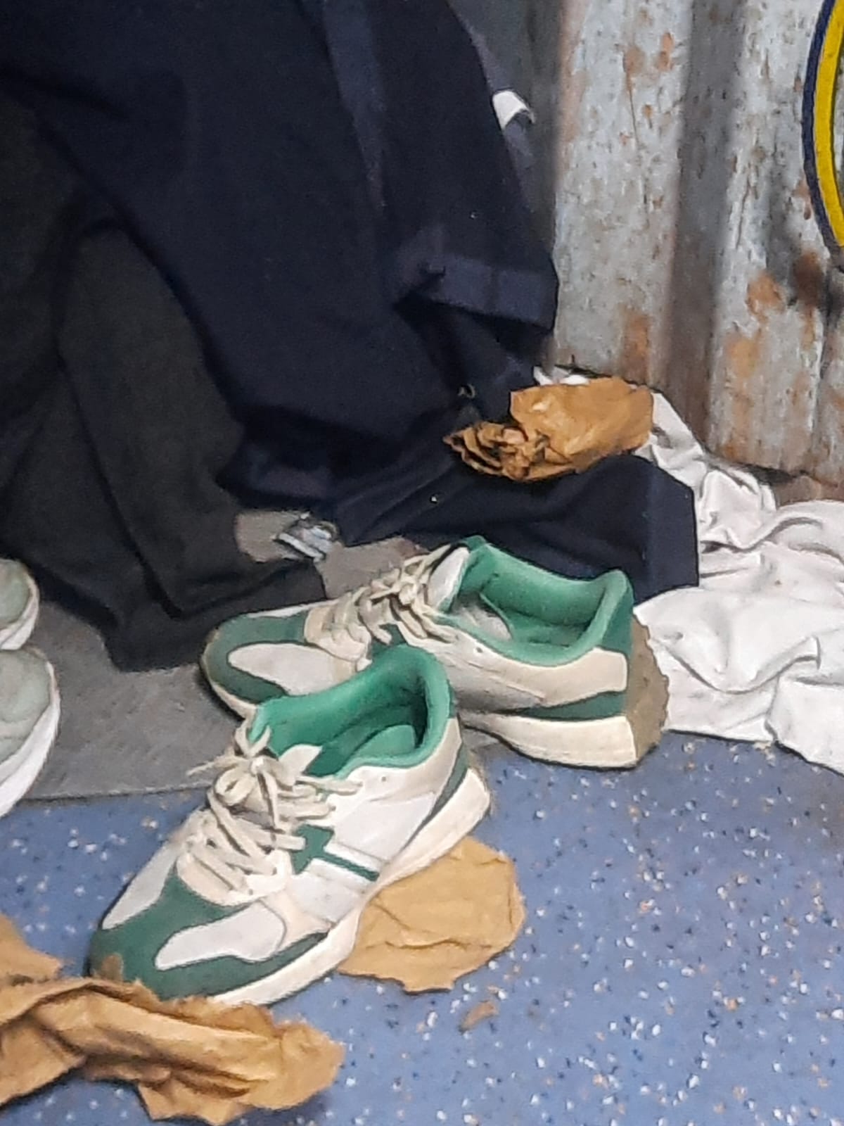 Vendor workers lying on the floor using blankets and sheets given to passengers, AC coach filled with spit and dirt