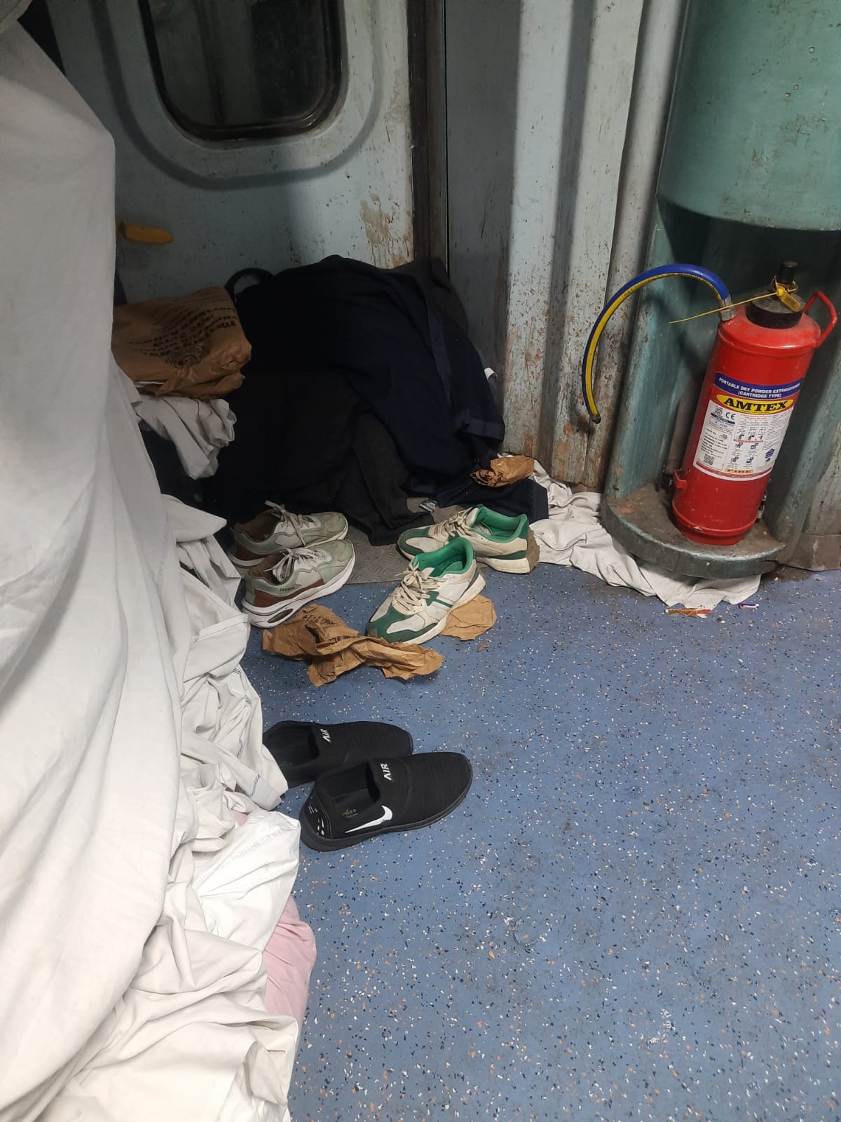 Vendor workers lying on the floor using blankets and sheets given to passengers, AC coach filled with spit and dirt1